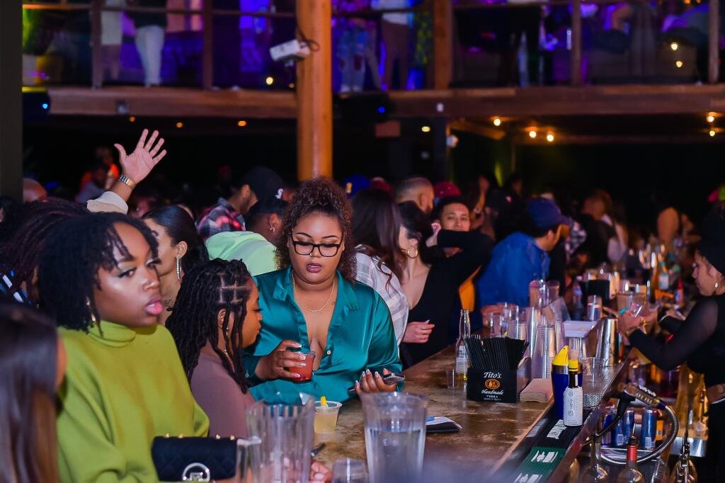 Guests gathered at the bar inside Zanzi Oakland
