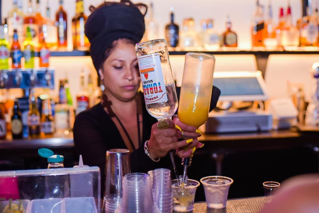 A bartender preparing a cocktail at Zanzi Oakland